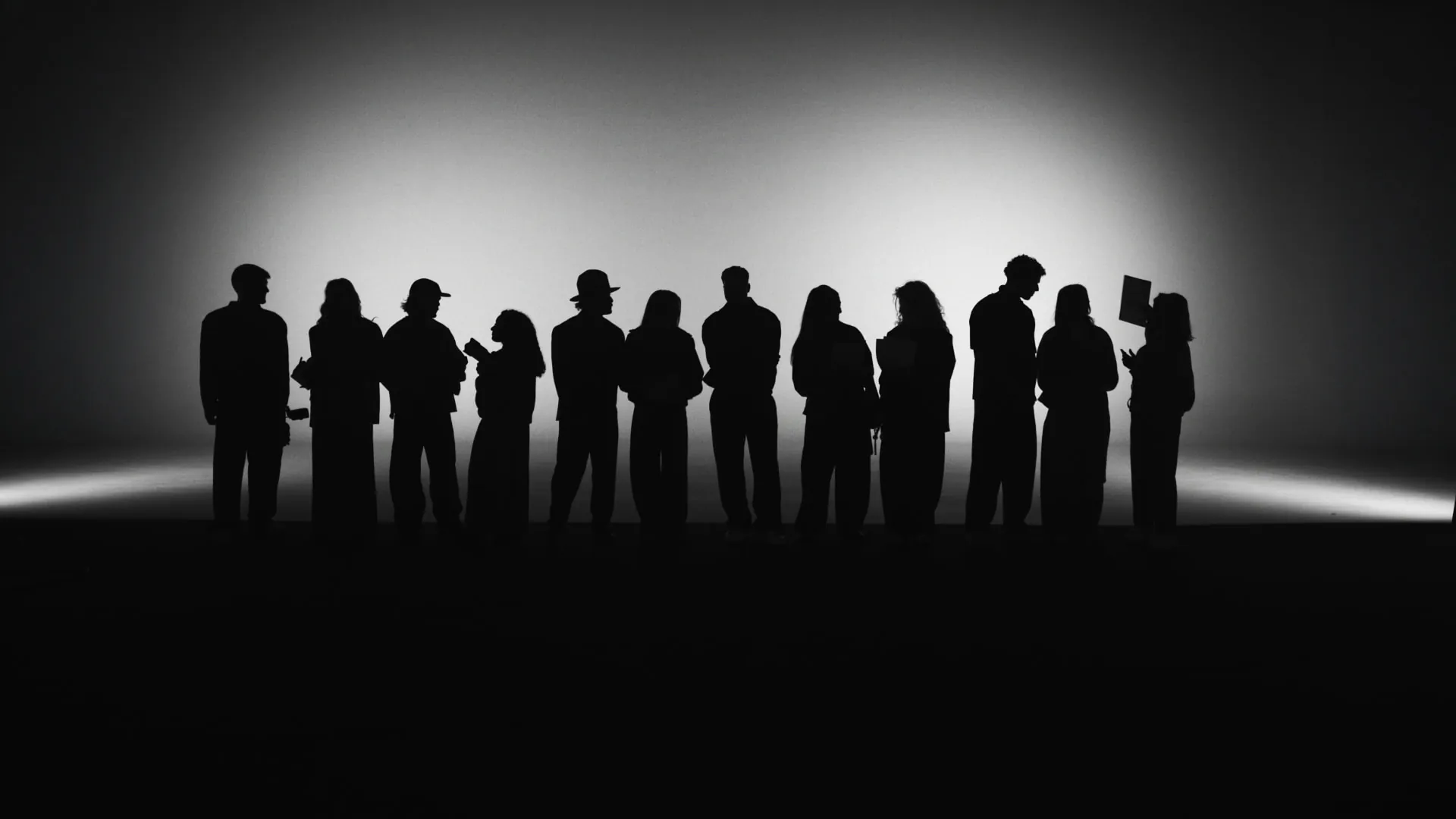 The team in silhouette, lined up in the studio